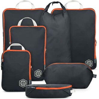 Set of black and orange travel packing cubes and bags.