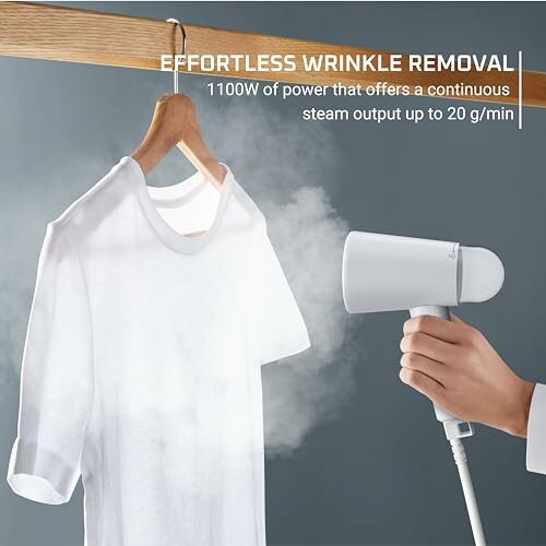 Person using handheld garment steamer on white shirt.