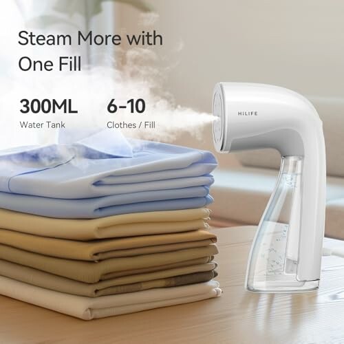 Handheld garment steamer next to folded clothes.