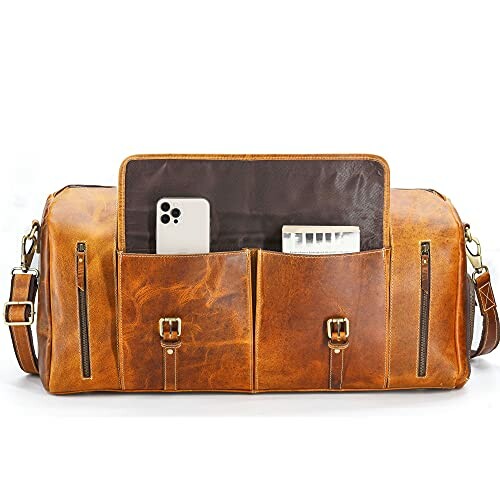 Brown leather duffel bag with pockets, containing a smartphone and a small electronic device