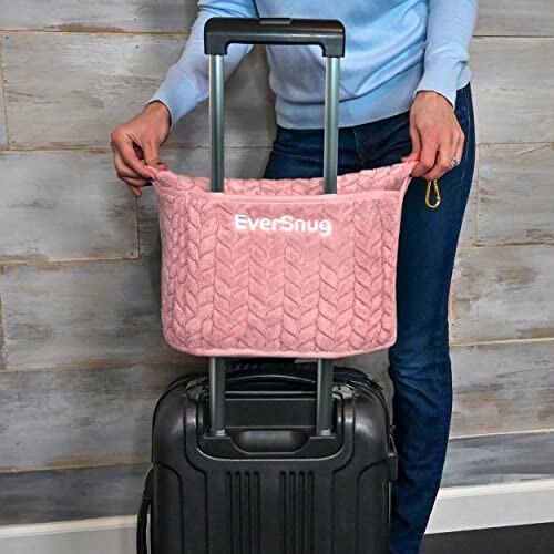 Person attaching pink cover to luggage handle