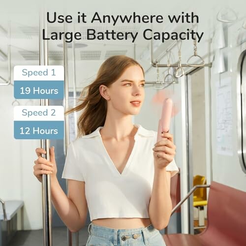 Woman using a portable fan on public transport.