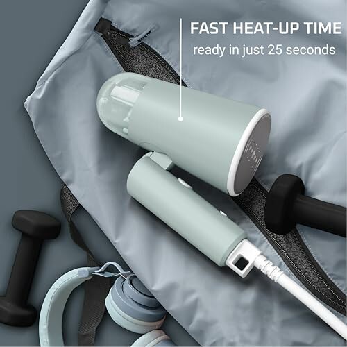 Portable steamer with fast heat-up time next to dumbbells and headphones.