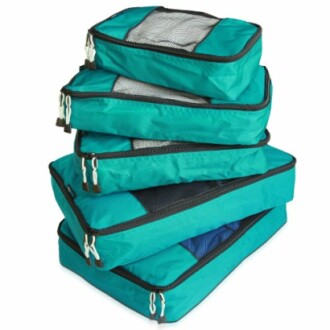 Stacked teal packing cubes with mesh tops.