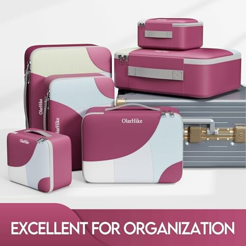 Set of pink and white travel organizer bags with suitcase.