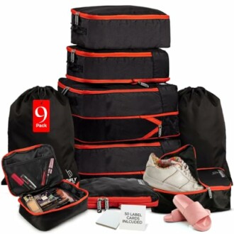 Set of black and red travel packing cubes with shoes and toiletries.