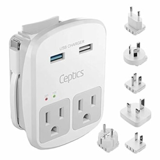 Universal power adapter with USB ports and interchangeable plugs.