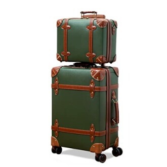 Green vintage suitcase set with brown leather straps.