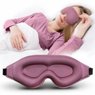 Woman wearing a purple eye mask sleeping in bed.