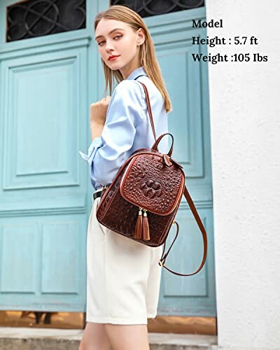 Woman in blue shirt with brown backpack